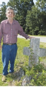 Shirley Burnham / The Prentiss Headlight—Dennis Broome, Jr. admits he wishes he had done more to preserve the now decaying cross cut in the tree trunk by lumberjacks from Montana removing trees downed by Hurricane Katrina.