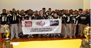 Shirley Burnham / The Prentiss Headlight—BHS Athletes and Coach Lance Mancuso accepted the  2014 Football Championship Banner from  Keith Bridges of Farm Bureau.