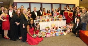The Prentiss Headlight—Members of JCJC’s JC Voices and JC Jazz are pictured with the toys they collected as donations before their “A Jingle Jazz Christmas” concert to donate to the Salvation Army’s Angel Tree program.   Pictured on the front row left to right at the bottom: Kacie McGowen and Phebe Tisdale.  Standing left to right on the front row on the left: Nathan Lucky, Allen Boleware (peeking), Ryan Ingram, Jordan Sanders (really peeking) and Zachary Biglane.  Standing in the second row on the left, left to right: Alexandria Parker, Stephen Jones, Simone Johnson, Rick Woodruff, and Devin Boothe. Pictured standing on the left: Sarah Conn and Kennedy Jarrell. Pictured left to right, on the back row along the wall: Bryce Kinzer, Harrison Bryant, Gary Young, Chancee Davis, Rohini Malkani, James Cooley, Jr., Amy Champion, Lamar Saddler. Pictured on the right in the back, left to right:  Zechariah Hall, Benjamin Husbands, Devin Vete, AJ Robinson, Terry Jackson, Reagan Arnold. Standing in the front row on the right, left to right: Anna Ruffin, Elizabeth Hensarling, Lydia Myers, Jan Walters (Salvation Army).  Pictured on the bottom front left to right: David Walker and Tony Garnand.
