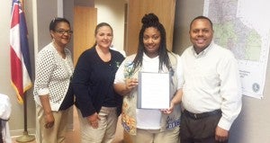 Holley Cochran / The Prentiss Headlight–JerNeka Laird presented District 4 Supervisor Michael Evans with a book recording the graves of over 30 cemeteries in District 4 in Jefferson Davis County. Also pictured are Girl Scout Leader Pat Ellis and Chancery Clerk Charlene Fairley.