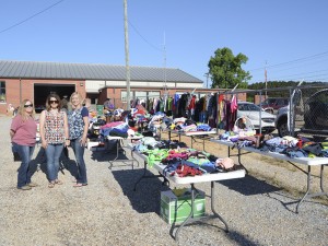 The Prentiss Headlight—Members of the Blue Line Wives organization that support law enforcement, Kristen Bullock, Dawn McRaney and Jessica Jackson help customers find treasures at the garage sale fundraiser held to raise money to buy laptop computers for the officers.