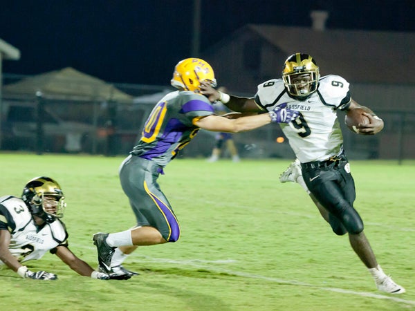 The Prentiss Headlight / Tony Waits—Yellowjacket Malik Shorts #9 stiff arms a Purvis defender in Friday night's loss against the Tornadoes.